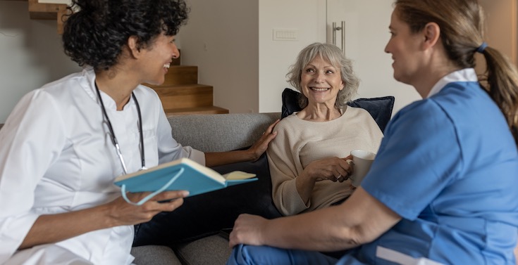 A clinician and care worker support a care receiver A clinician and care worker support a care receiver